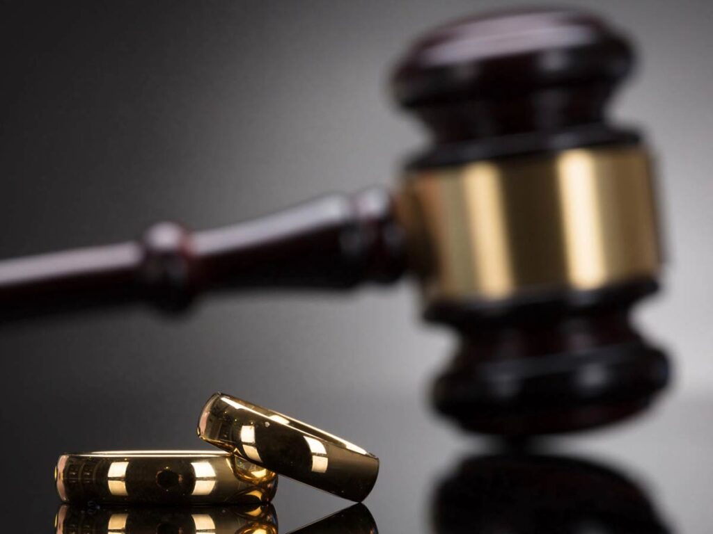 Golden Wedding Rings In Front Of Gavel